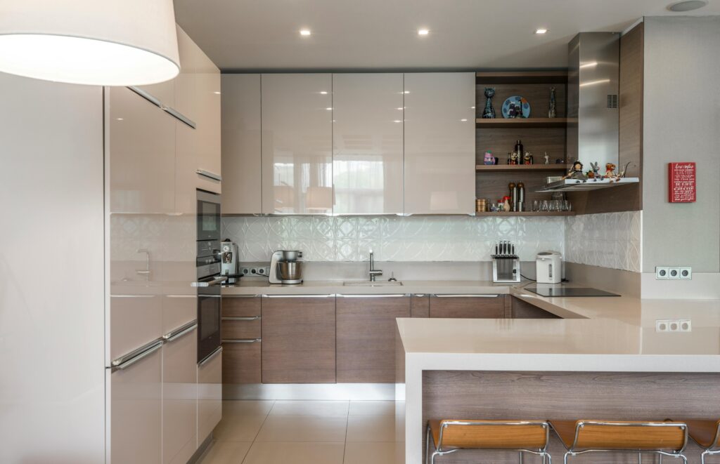 Sleek modern kitchen with white cabinets, island, and built-in appliances.