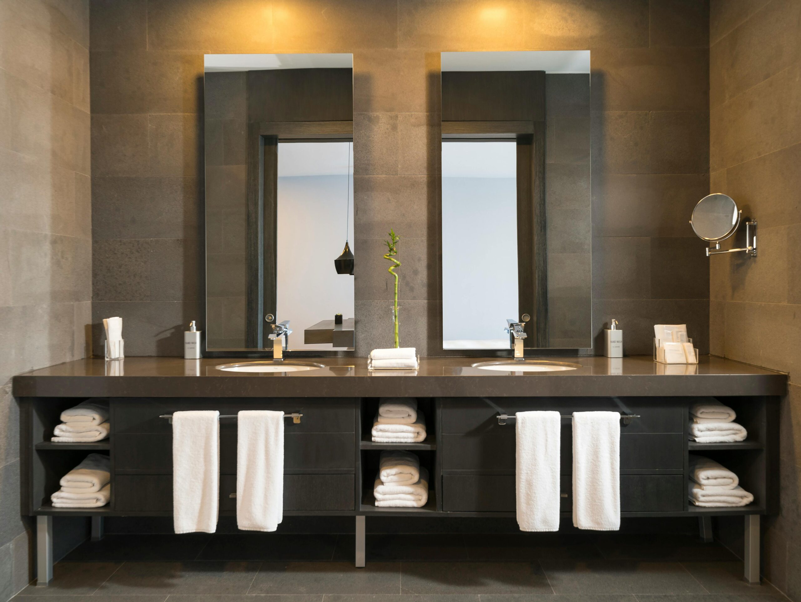 Sleek minimalist bathroom with a modern illuminated faucet and washbasin.